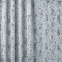 a close up view of a blue and white curtain