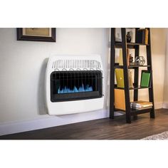 a white wall mounted heater sitting on top of a wooden floor next to a book shelf