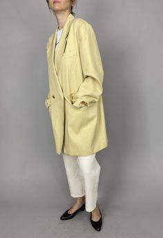 "Vintage Wool Blazer for Women Size L - XL | Pale Yellow Long Wool Blazer, fully lined, with big golden metallic buttons. Gorgeous blazer. Composition: 100% wool. Lining: 100% rayon. Measurements of the vintage wool blazer lying flat: Armpit to armpit: 58 cm | 22.8\" Length: 89 cm | 35\" Sleeves: 62 cm | 24.4\" Shoulder to shoulder: 47 cm | 18.5\" Waist: 53 cm | 20,9\" In beautiful vintage condition. This pale yellow wool blazer is photographed on a size S model (bust: 88 cm|35\", waist: 68|26\" Gold Blazer With Double Button For Workwear, Gold Blazer With Double Button Closure For Work, Elegant Yellow Blazer With Pockets, Gold Blazer For Office In Spring, Gold Spring Blazer For Office, Gold Outerwear For Work In Spring, Gold Tailored Double-breasted Outerwear, Classic Yellow Blazer For Office, Classic Yellow Blazer For Business