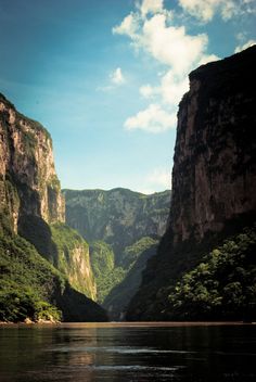 a river with mountains in the background