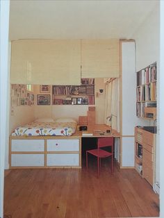 a room with a bed, desk and bookshelf