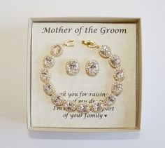 a mother of the groom bracelet and earrings set in a gift box with an inscription on it