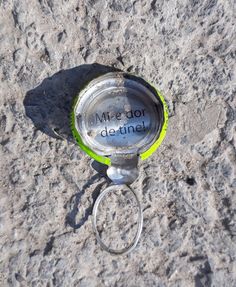 a bottle opener with the word me do not detting on it sitting in the sand