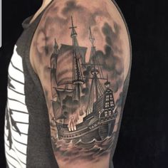 a man with a ship tattoo on his arm