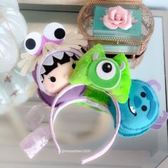 several stuffed animals are on display in a glass case, including one with eyes and headbands