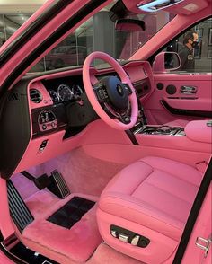 the interior of a pink car is clean and ready for customers to ride in it