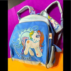 My Little Pony Vintage 2003 Nwt Collectable Sunny Daze Pony 2tone Blue Canvas Backpack With Matching Pencil Case, Backpack Has Adjustable Approxto 32” Padded Straps, 2 Side Pockets W/Heart& My Little Pony Logo Velcro Closure, 2 Large Compartments That Zip Close, Front Of Backpack Has Large Embossed Sunny Daze Pony W/Embroidered Outline, Sparkle Sun, Sunny Daze Body White Velour Type Material, Lg Compartment Has Embossed Sun Outside, Inside Has Name Tag Protector, Quilted Vinyl Lined For Easy Was Rectangular Orange Backpack For School, My Little Pony Backpack, My Little Pony Vintage, Vintage Backpacks, Childhood Toys, Blue Canvas, Canvas Backpack, Zipper Top, Pencil Case