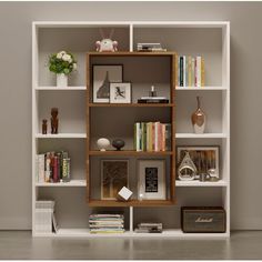 a white book shelf filled with lots of books