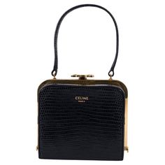 100% authentic Celine Lana Minaudière evening bag in black lizard (varanus salvator) featuring gold-tone finish hardware with Triomphe closure and black lambskin lining. Has been carried once or twice and is in virtually new condition. Comes with dust bag. Measurements Model 197244COE.38NO Height 9cm (3.5in) Width 10cm (3.9in) Depth 7cm (2.7in) Drop of the Handle 9cm (3.5in) Hardware Gold-Tone All our listings include only the listed item unless otherwise specified in the description above Black Lizard, Structured Shoulder, Fashion Handbags, Evening Bags, Bags Handbags, Dust Bag, Shoe Accessories, Bag Lady, Women Accessories