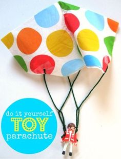 a toy parachute is being held by two small people with colorful polka dots on it