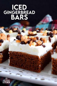 an iced gingerbread bar with chocolate chips and marshmallows on top, sitting on a white platter