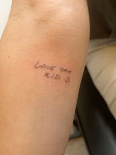 a woman's arm with the words i love you, kid written on it