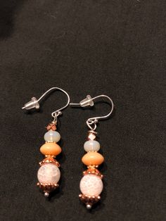 Frosted white glass, rose gold, coral beaded earrings.  Sterling silver ear wires. White Copper Earrings As Gift, Elegant Orange Czech Glass Jewelry, White Wire Wrapped Round Bead Earrings, White Wire Wrapped Beaded Drop Earrings, White Beaded Wire Wrapped Drop Earrings, Elegant White Beaded Earrings With Czech Glass, Elegant White Czech Glass Beaded Earrings, Rose Gold Beaded Dangle Jewelry, Rose Gold Beaded Earrings With Round Beads