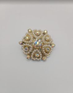 A beautiful Australian Opal brooch, perfect for elevating an evening outfit, with the endless and multicoloured reflection of the opal stones. White Brooch Jewelry For Evening, White Evening Jewelry With Brooch, White Rhinestone Brooches For Formal Occasions, White Ornate Brooch For Formal Occasions, White Ornate Brooches For Formal Occasions, Formal White Brooches With Rhinestones, Ornate White Brooches For Formal Occasions, Formal White Rhinestone Brooches, Glamorous Crystal Brooch As Gift