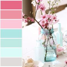 a jar with flowers in it sitting on a table next to other bottles and jars