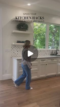 a woman is walking through the kitchen