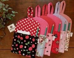 several small purses are lined up next to each other on a table with flowers and polka dots