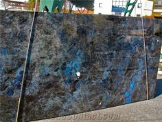 a large blue marble slab sitting on top of a sidewalk