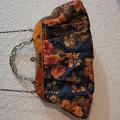 a purse hanging on the wall with chain