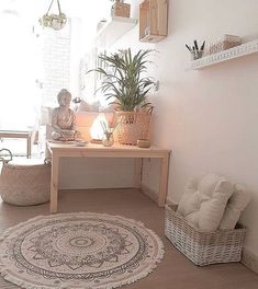 a living room with a rug, chair and potted plant