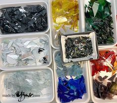 several trays filled with different colored glass shards