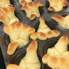 freshly baked bread shaped like hands sitting in a muffin tin, ready to go into the oven