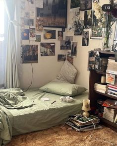 a bed sitting in a bedroom next to a book shelf with books on top of it