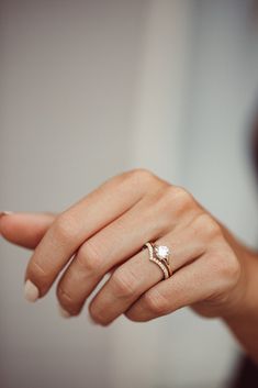 a woman's hand with a ring on it