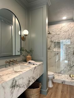 a bathroom with marble counter tops and walls