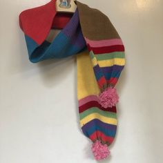 a multicolored scarf hanging on the wall