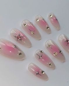 pink and white nails with gold stars on them