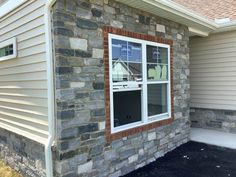 a brick house with white trim and windows