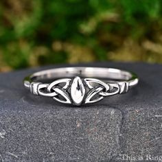 a silver ring sitting on top of a rock