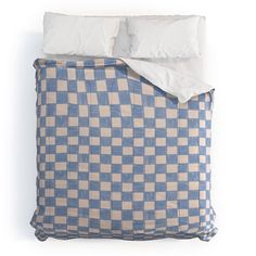 a blue and white checkered comforter set with two pillows on the bottom side