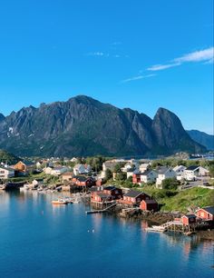 an island with houses and mountains in the background