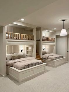 two beds in a room with white carpeting and bunk beds on the other side