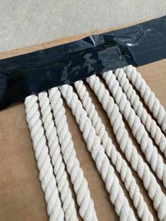 several white ropes are laid out on the ground