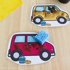 two stickers with cars on them sitting on a table