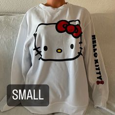 Hello Kitty Crewneck Sweater Size: Small Color: White Details: Has Hello Kitty Face On The Front And “Hello Kitty” Whit A Bow On The Left Arm Sleeve, Has Nothing On The Back New Without Tags! Price Firm! Hello Kitty Sweatshirt, Hello Kitty Bow, Bow Sweater, Arm Sleeve, White Sweaters, Colorful Sweaters, Crew Neck Sweater, Sweater Sizes, Sweaters For Women