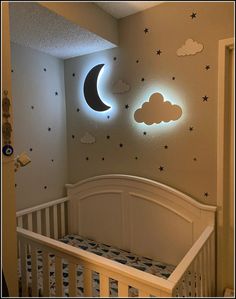 a baby's room decorated with stars and moon lights