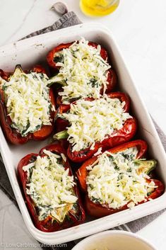 baked stuffed peppers with cheese and herbs in a casserole dish, ready to be eaten