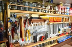 there are many tools on the shelves in this garage storage area that is organized with pegs