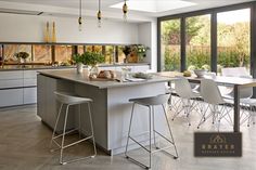 a kitchen with an island and bar stools