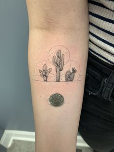 a small cactus tattoo on the arm