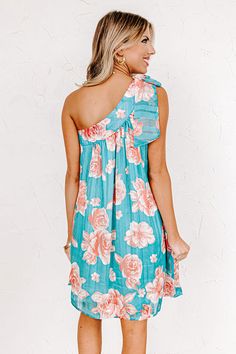 Believe us when we say you'll want this beautiful turquoise dress to be yours forever with its lightweight breezy material, large light pink/coral hued floral print, a diagonal neckline and upper back with a single bow tie closure shoulder straps, hidden side pockets, and a relaxed silhouette that falls into a straight mid-thigh length hemline! on products Measurements S : Bust 34", Hip 44", Length 31", Waist 38". M : Bust 36", Hip 46", Length 32", Waist 40". L : Bust 38", Hip 48", Length 33", W Be Mine Forever, Mine Forever, Turquoise Dress, Patent Heels, Pink Coral, Be Mine, Model Fits, Women Clothing Boutique, Hip Length