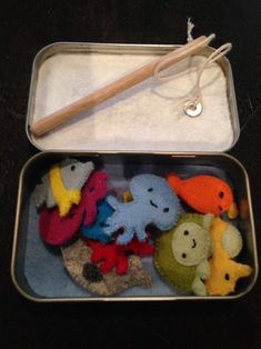 an open tin with some stuffed animals in it