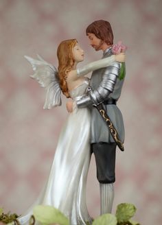 a figurine of a man and woman holding each other