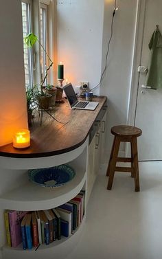 a room with a desk, stool and bookshelf