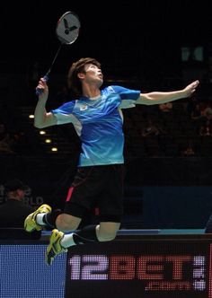 a man jumping up in the air to hit a tennis ball with his racket