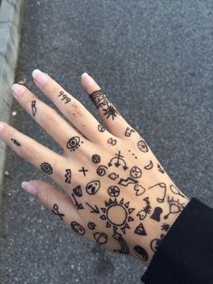 a person's hand with tattoos on it